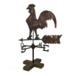 A copper coloured cockerel weather vane, 20th century, mounted on a wooden base, 82.5cm high.