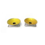 A pair of Danish silver and yellow enamelled candle stands, each of dished circular form,