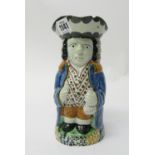 A Yorkshire Pratt ware Toby jug, circa 1810, ochre, blues and greens, in typical standing pose,
