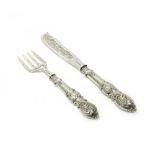 A pair of Victorian silver fish servers, with pierced and scroll engraved decoration,