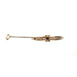 A gold, seed pearl and garnet set bar brooch, in a pierced openwork design, with foliate motifs,