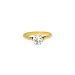 A gold and diamond single stone ring, claw set with a cushion shaped diamond, the shank unmarked,