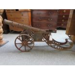 A cast and wrought iron cannon, 20th century, with triple knopped tapering barrel (95cm long),