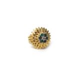 A gold, emerald and diamond cluster ring designed as a flowerhead,