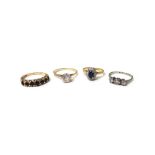 A diamond set three stone ring, claw set with circular cut diamonds, a gold and platinum,