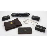 A Victorian black papier mache and abalone shell spectacles case, containing a pair of spectacles,