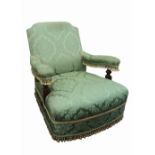 A late Victorian walnut frame armchair, upholstered in green floral figured and tasselled damask,
