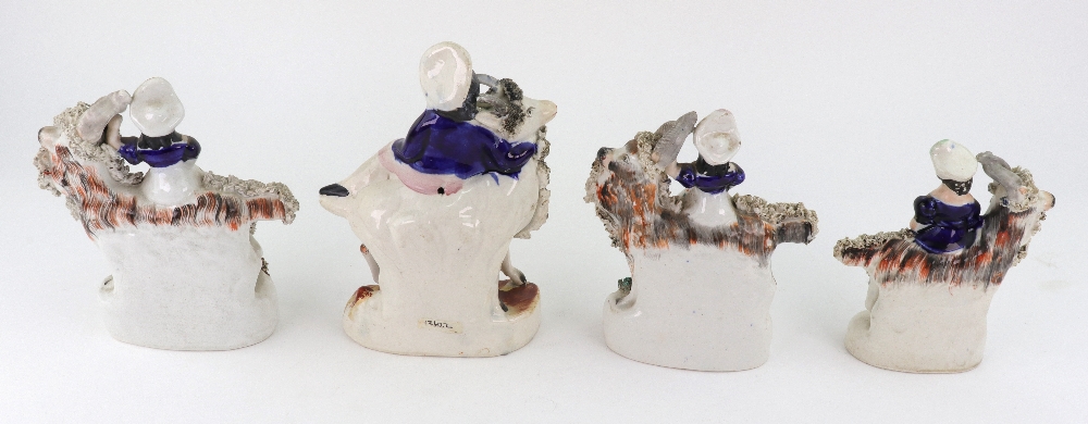 A pair of Staffordshire figures of children kneeling on goats and holding birds, - Image 5 of 5