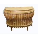 A pair of reproduction pine demi lune commodes, the moulded tops above a shallow drawer,