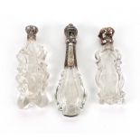 Two Dutch silver mounted cut glass perfume bottles, 19th century, of shaped oval section,