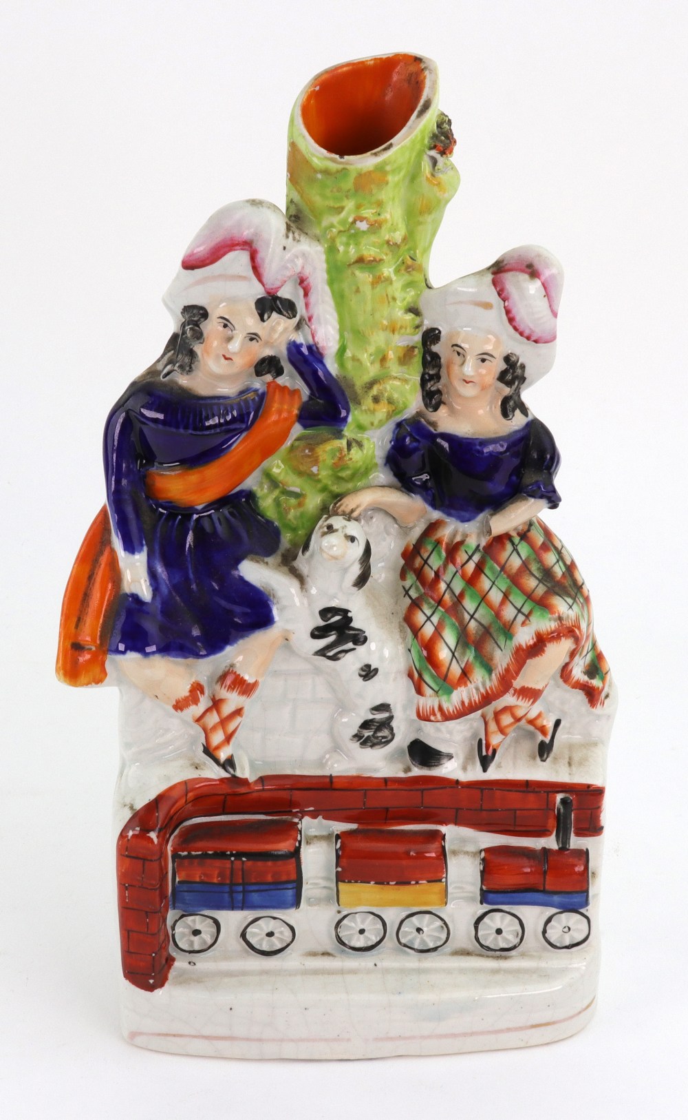 A Staffordshire pottery group of two children in highland clothes, a dog between them,