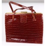 A vintage Asprey crocodile skin handbag, circa 1960s/70s, with fitted interior,