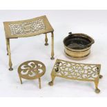 A late 18th/early 19th century brass footman or trivet, the curved rectangular pierced top,