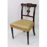 A Regency mahogany dining chair with shaped and pierced splat, stuff over seat, on turned legs,