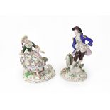 Two Sitzendorf porcelain figures, modelled as a shepherd and shepherdess, each with sheep,