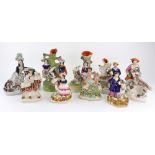 A pair of Staffordshire pottery figures of a boy and a girl standing before goats,