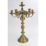 A Dutch brass seven light candleabrum, in 18th century style, with scrolled branches,