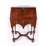 A reproduction William & Mary style walnut cross and feather banded bureau,