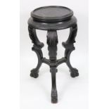 An ebonised vase stand, late 19th century, the moulded circular top,