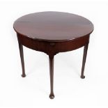 A mid 18th century mahogany demi lune tea table, the hinged fold over top concealing a compartment,