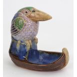 A Doulton Lambeth stoneware bibelot modelled with a Kookaburra on a boat-shaped base,