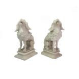 A pair of carved white alabaster models of seated clipped poodles, second half 19th century,