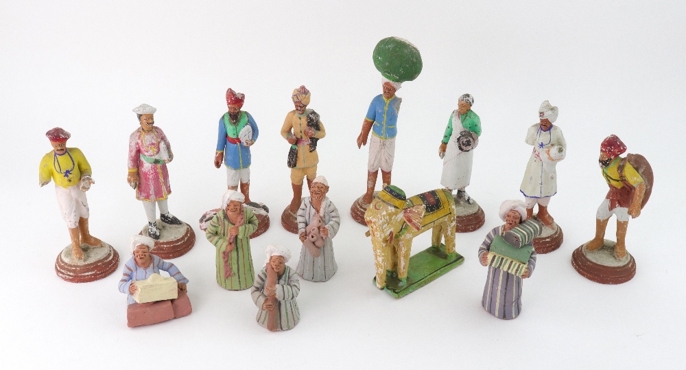 A set of eight Indian painted terracotta figures, 13 - 17cm high,