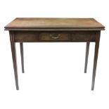 A George III mahogany fold over top tea table, with frieze drawer, on moulded square tapered legs,