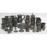 A collection of pewter wares, 19th/20th century, including measures in varying sizes, condiments,