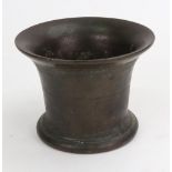 A bronze mortar, 18th century, with flared rim, line decorated sides,