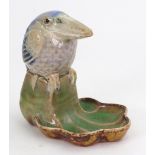 A Doulton Lambeth stoneware bibelot modelled with a Kookaburra on a shell-shaped base,