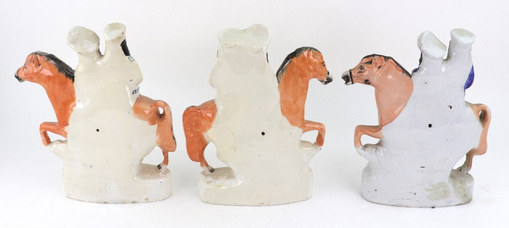 A pair of Staffordshire pottery figures of a boy and girl on horseback jumping fences, 16cm high, - Image 3 of 5