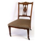 An Edwardian rosewood boxwood strung and inlaid nursing chair, with stuff over seat,