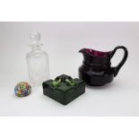 An amethyst glass water jug, bulbous form, with scroll handle, a Stuart square cut glass decanter,