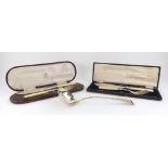 A cased pair of Victorian ornate electroplate fish carvers,