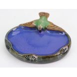 A Doulton Lambeth stoneware bibelot modelled with a bird on a boat-shaped base, in coloured glazes,