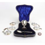 A cased silver egg cup, Wakely & Wheeler, Dublin 1916, and a silver spoon, Mappin & Webb,