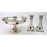 A pair of Scottish Arts & Crafts electroplate candlesticks and matching fruit stand, stamped J. B.