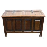 A reproduction 17th century style oak coffer, of raised and fielded panelled construction,
