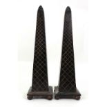 A pair of reproduction bronzed obelisks, on ball feet, 45cm high.