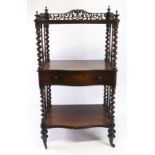 A Victorian rosewood serpentine fronted three tier whatnot, circa 1860,