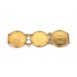 An oval link bracelet set with three South African Krugerrands, 1974, with a safety chain,