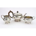 A three piece circular silver tea service, Mappin & Webb, London 1929, with 'Celtic borders',