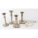 A pair of George III style silver candlesticks, S.