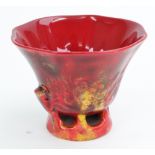 A Royal Doulton flambé cup by Charles Noke, modelled as a libation cup, moulded prunus,