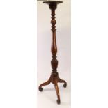 A reproduction walnut torchere, in early 18th century style, with baluster,