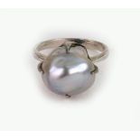 A baroque pearl ring, the slightly grey tinted bead approximately 11-13mm diameter,