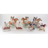 A pair of Staffordshire pottery figures of a boy and girl on horseback jumping fences, 16cm high,