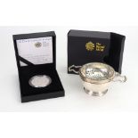 A George II style silver two handed circular strainer, Goldsmiths & Silversmiths Company,