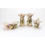 A Sitzendorf porcelain garniture of four vases, circa 1900, each encrusted with flowering branches,